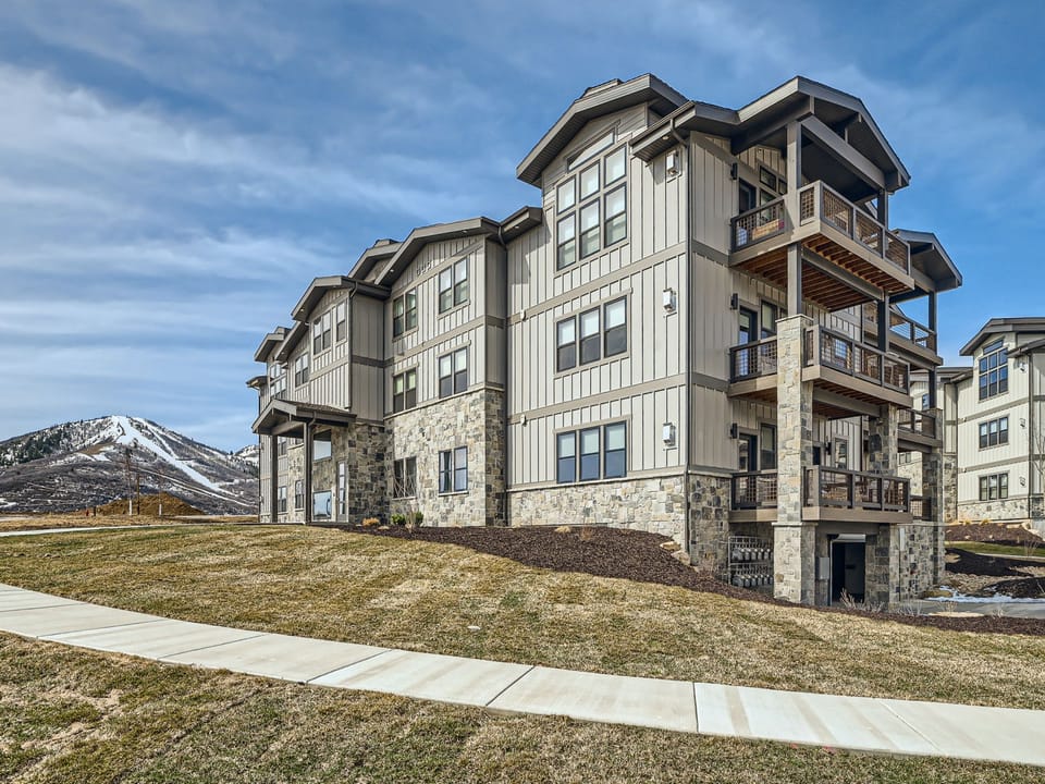 This luxury Park City townhome offers a classic mountain exterior with vaulted ceilings and stone-wrapped chimneys