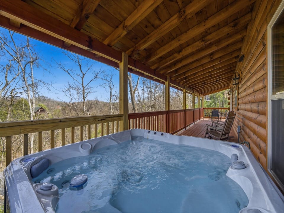 Soak in your private hot tub while enjoying peaceful forest views from this covered deck.