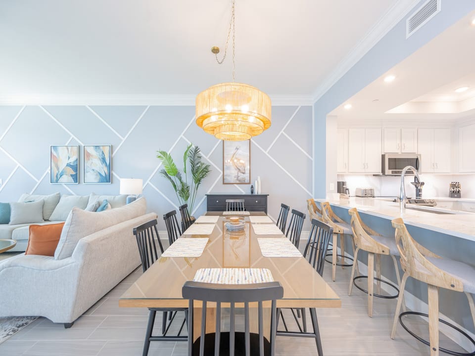 Gather around the inviting dining table, where laughter and connection create lasting family memories amidst coastal decor