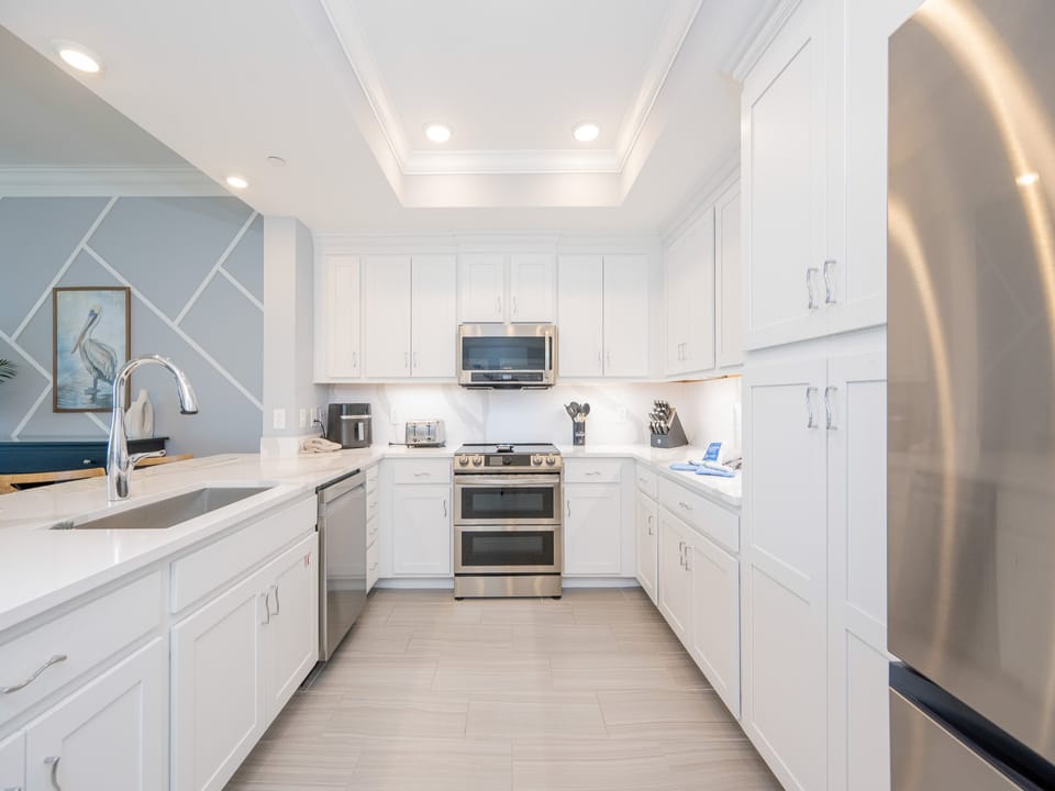 Upgrade your culinary experience in this stylish kitchen with modern stainless appliances and elegant design
