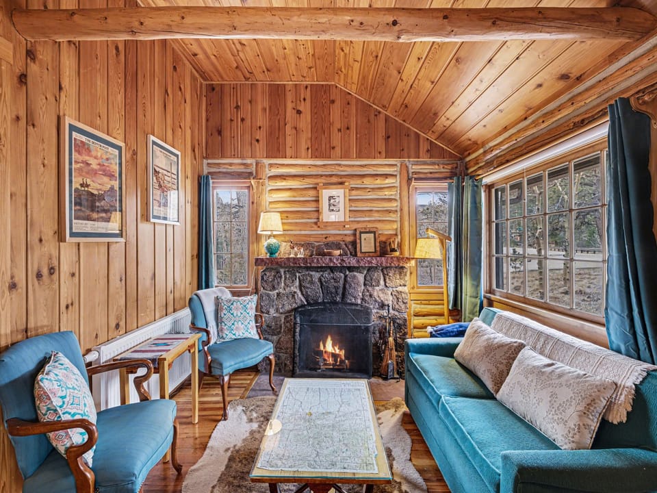 Settle into your cozy mountain retreat where warm wood surrounds you and a crackling fireplace creates perfect moments for relaxation.