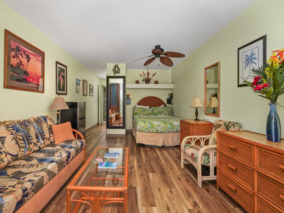 Relax in your tropical-themed studio with comfortable seating, cozy bed nook, and island-inspired décor creating the perfect Hawaiian getaway vibe.