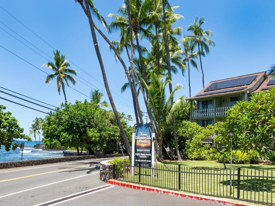 Tropical paradise entrance with swaying palms and ocean views sets the scene for your Hawaiian getaway.