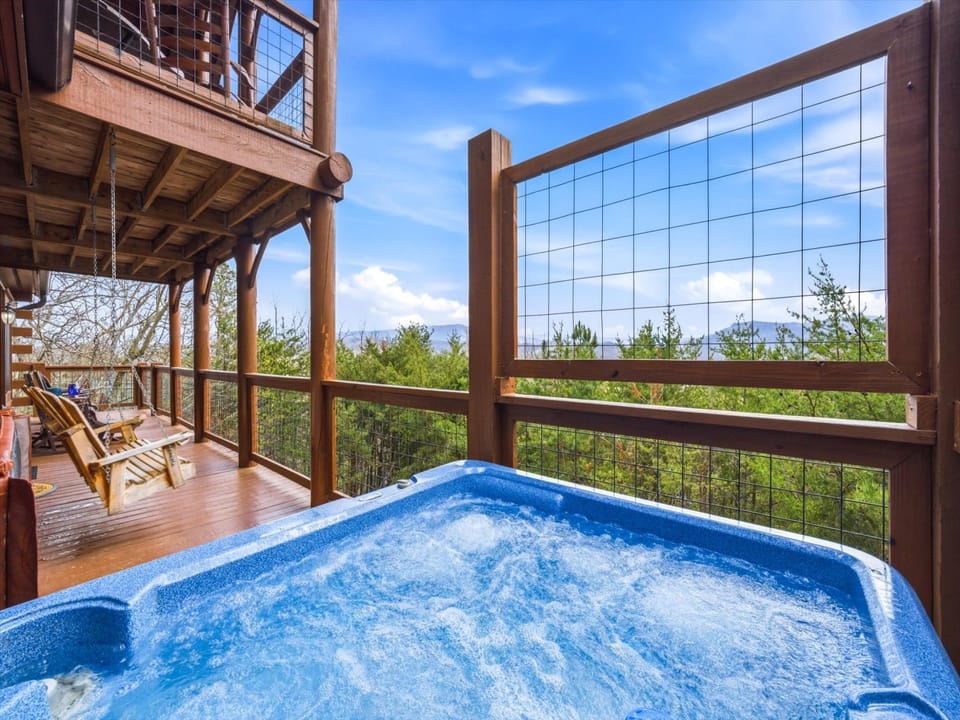 Soak in your private hot tub while enjoying stunning mountain views from this elevated deck paradise.