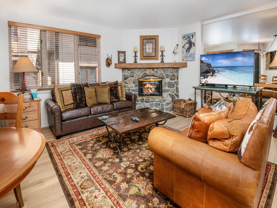 Sink into rich leather sofas and warm yourself by the stone fireplace, your cozy mountain retreat awaiting your arrival.