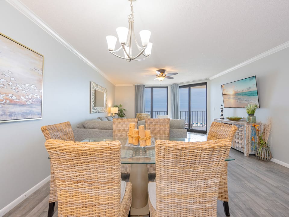 Sunlight streams through sliding doors inviting you to relax in the living room with a sofa queen near the coast view