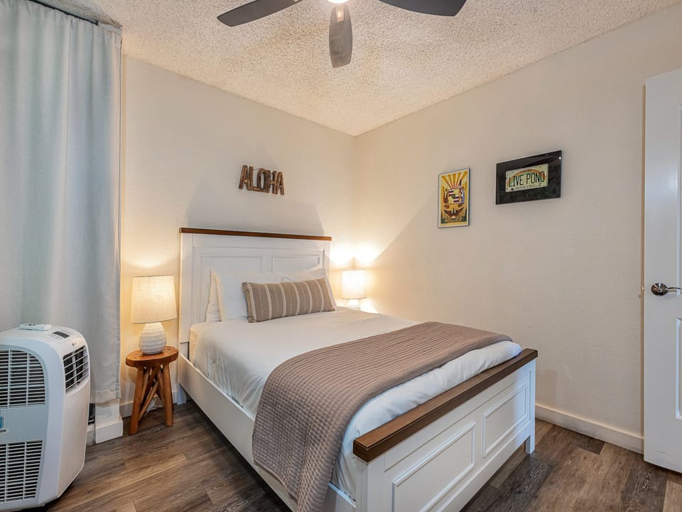 Drift off to sleep in your peaceful bedroom, complete with thoughtful touches like a cooling ceiling fan and portable AC.