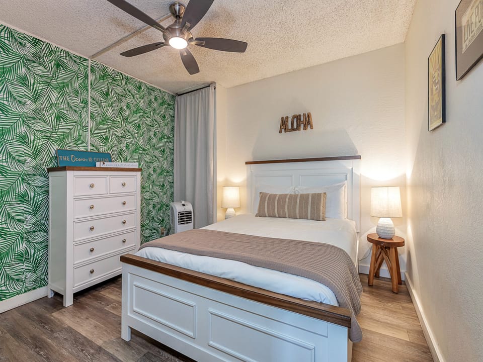 Unwind in your tropical-themed comfy bedroom with crisp linens and warm touches that create your perfect island escape.