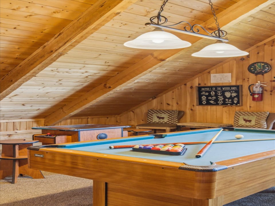 Challenge friends to pool in this cozy wood-beamed loft game room, complete with comfortable seating for spectators.