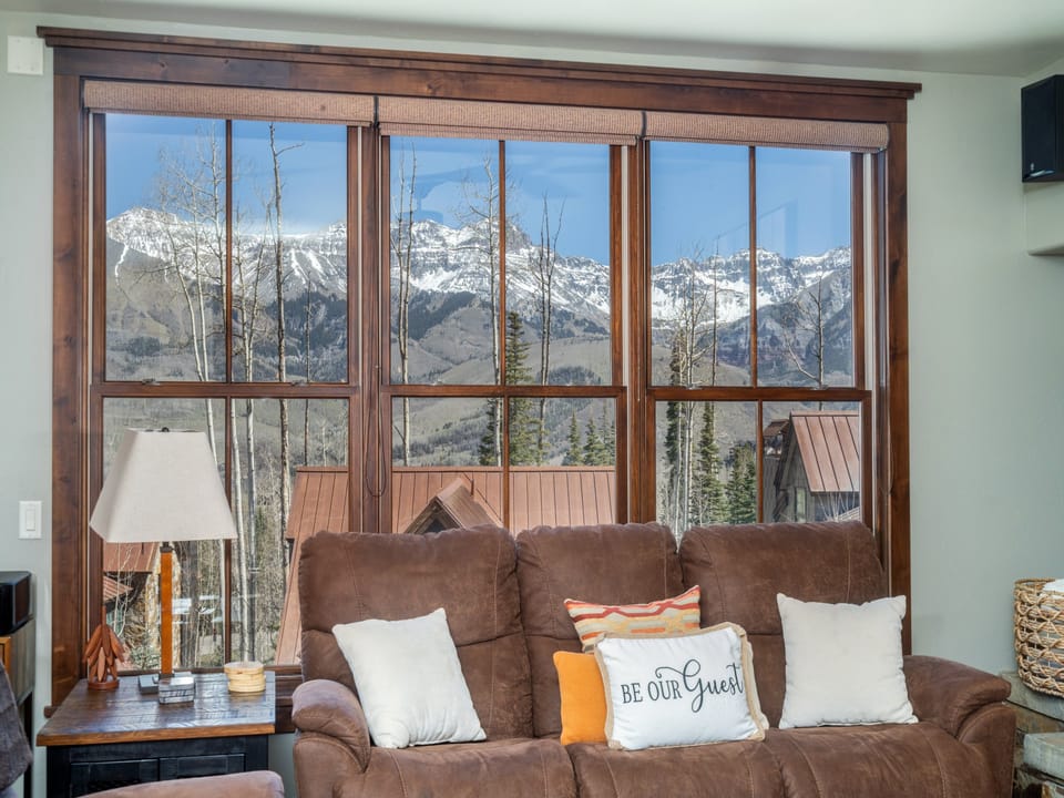 Sink into this plush sectional and gaze through stunning picture windows at snow-capped peaks. Your mountain sanctuary awaits with cozy comfort and breathtaking alpine views.