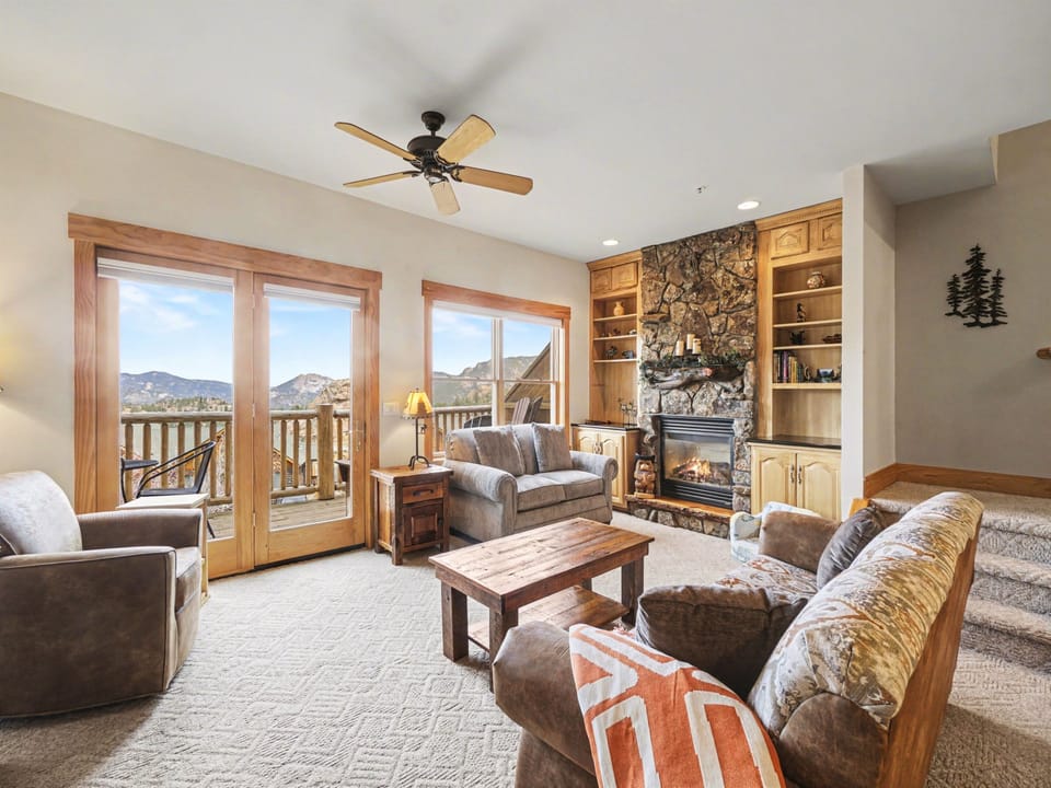Sink into plush leather seating by your stone fireplace while mountain views stretch beyond French doors to your private balcony.
