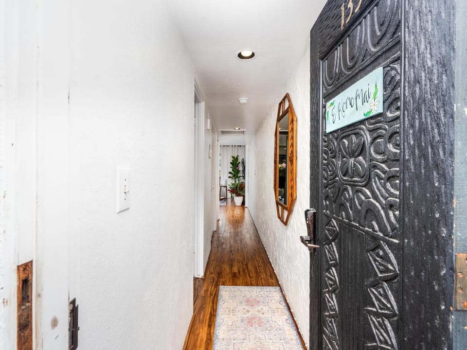 Step into your private hallway where rich hardwood floors and thoughtful details create a warm welcome home.