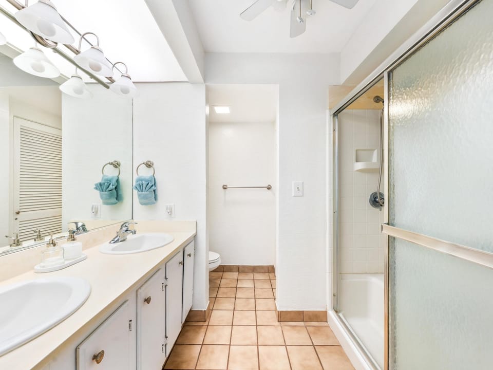 Step into your spacious bathroom with dual vanities, ample storage, and a refreshing walk-in shower—perfect for preparing for your adventures.