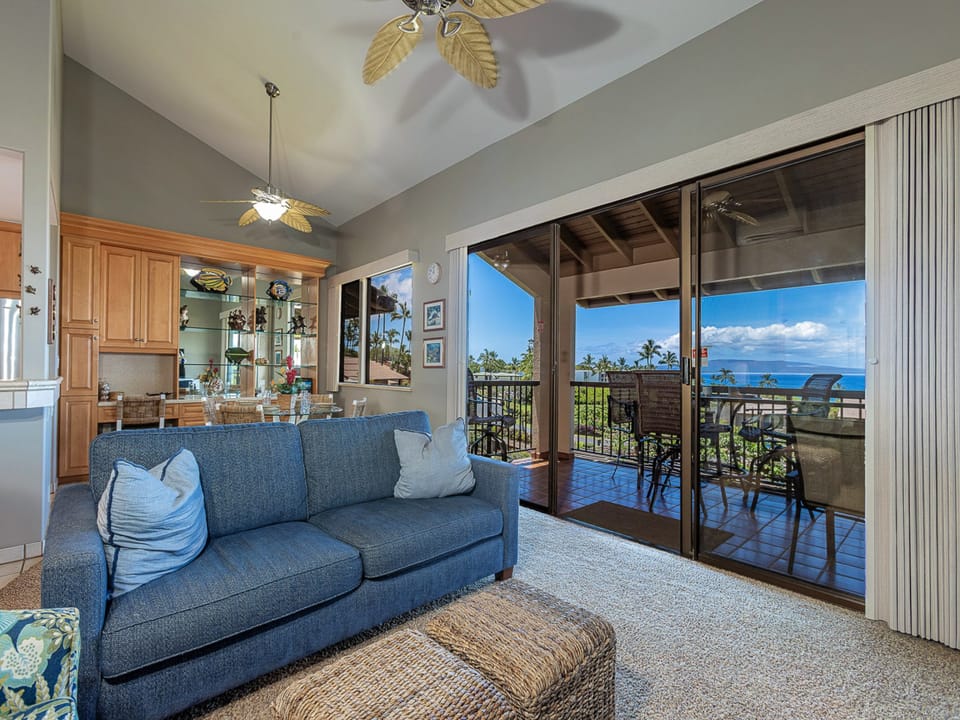 Relax on your comfortable sofa while enjoying stunning ocean views through floor-to-ceiling windows that open to your private balcony paradise.