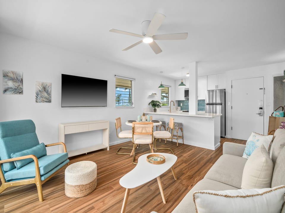 Open living space with coastal-inspired décor, modern kitchen, and dining nook—perfect for unwinding after a day of exploration.