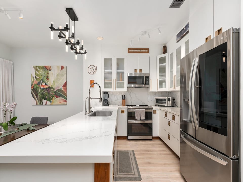 Your gourmet kitchen features marble counters, stainless steel appliances, and modern lighting - perfect for cooking memorable meals together.