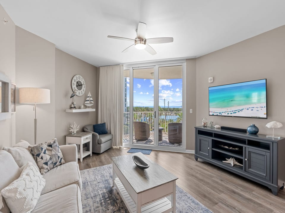 Your bright, coastal-themed living space opens to a private balcony, where you can unwind with ocean breezes and enjoy serene views of the surrounding landscape.