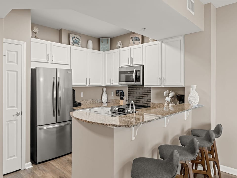 Step into your fully equipped kitchen with stainless appliances, granite counters, and a breakfast bar—perfect for preparing meals and gathering with friends.