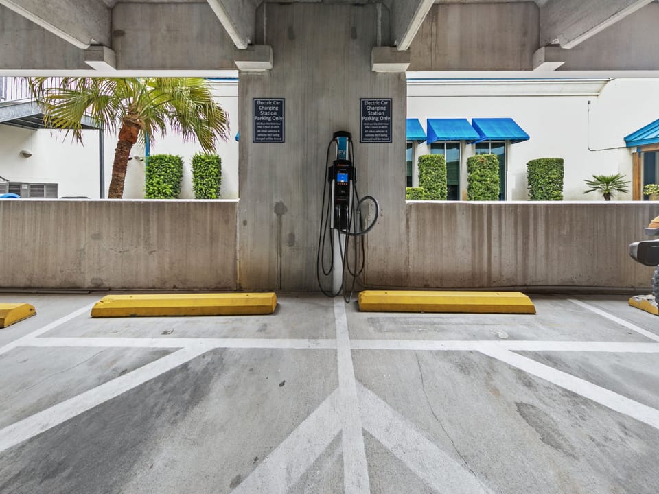 Covered parking area with dedicated electric vehicle charging station, providing convenient and modern amenities for guests during their stay.