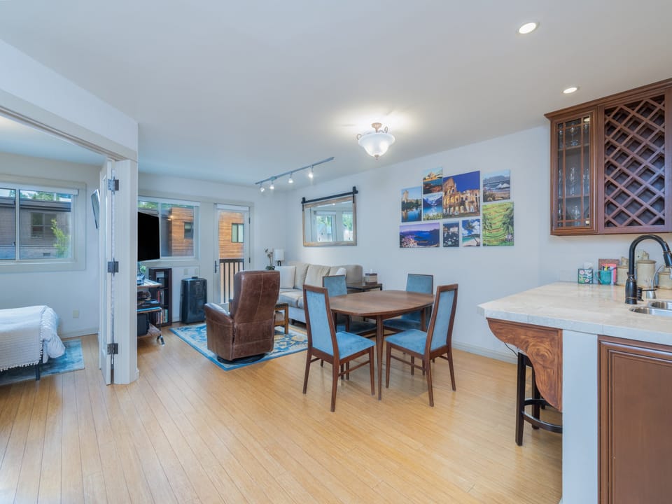 Bright, open living space with warm wood floors, dining for four, and a cozy bedroom just steps away—perfect for unwinding after your adventures.