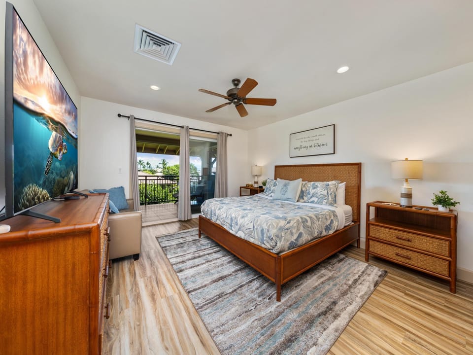 Unwind in your coastal-inspired bedroom featuring a plush king bed, private balcony, flat-screen TV, and calming ocean-themed décor—your perfect retreat after island adventures.