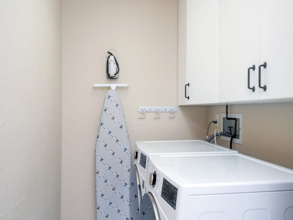 Bright laundry space with modern machines and an ironing station makes your stay convenient and comfortable—tackle any wardrobe need with ease.