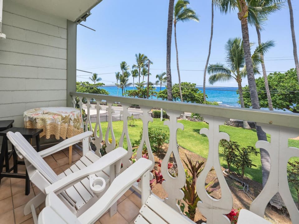 Relax on your private balcony with stunning sea views framed by swaying palms. Watch the azure ocean shimmer beyond the lush tropical gardens while you unwind in coastal serenity.