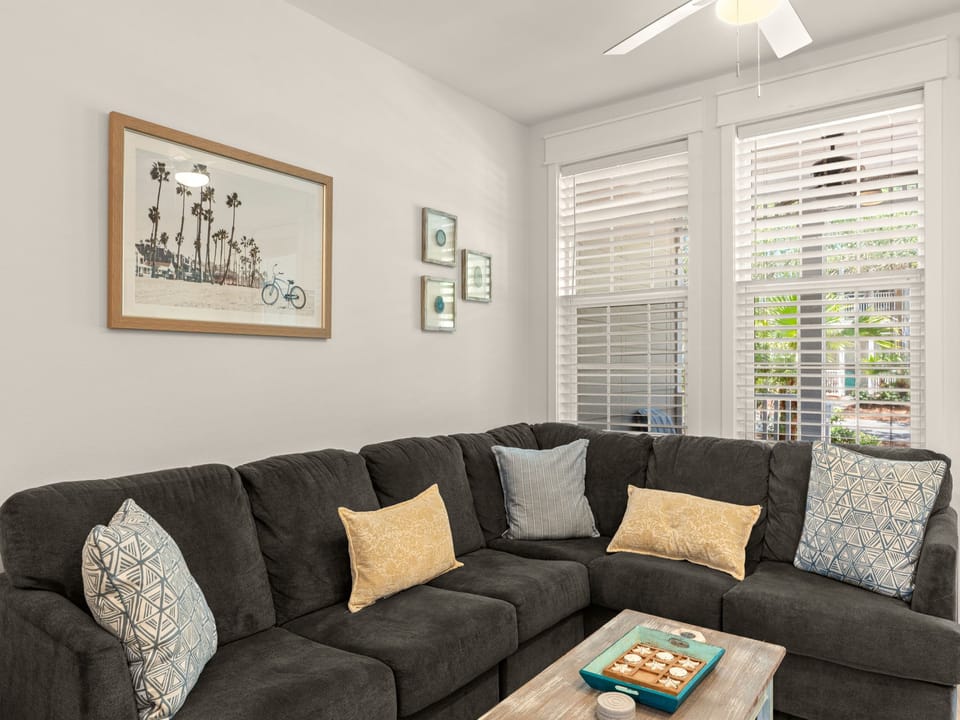 Sink into the plush sectional and unwind in your bright, airy living room—perfect for cozy movie nights or catching up after a day exploring the coast.