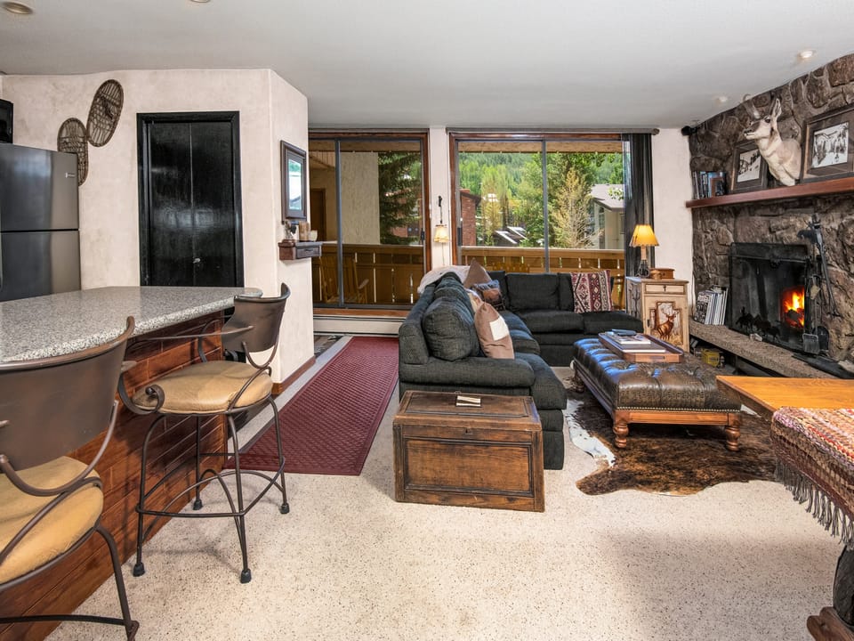 Unwind by the crackling stone fireplace, sink into plush seating with mountain views streaming through your windows, and let this cozy retreat become your home away from home.