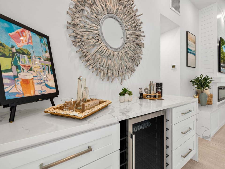 Your private bar awaits with elegant marble counters, sleek wine storage, and a stylish setup for mixing your favorite drinks in this sophisticated space.