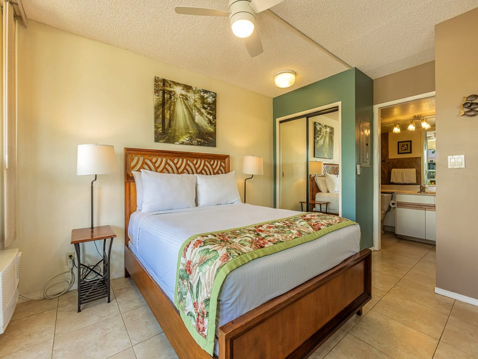 Your inviting bedroom with soft linens. All cooled by a gentle ceiling fan overhead and window AC..