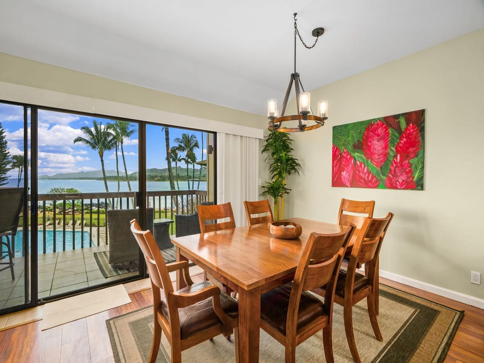Gather around the warm wood table where meals become memories, with tropical breezes and stunning water views setting the perfect scene for your island escape.