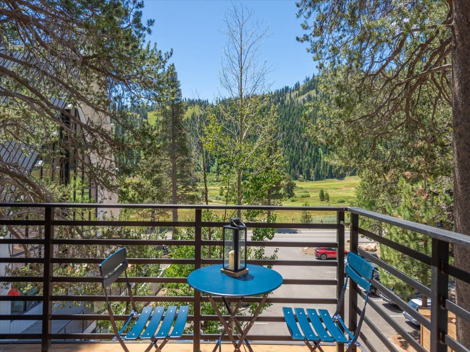 Sip your morning coffee on this private balcony as forested mountain slopes and meadows stretch endlessly before you—your peaceful retreat surrounded by nature.