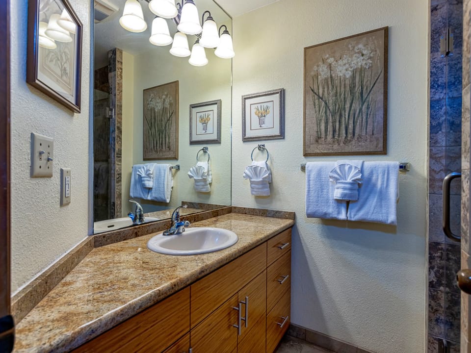 Bathroom with elegant décor, warm lighting, and freshly folded towels waiting for your arrival—designed for comfort and relaxation.