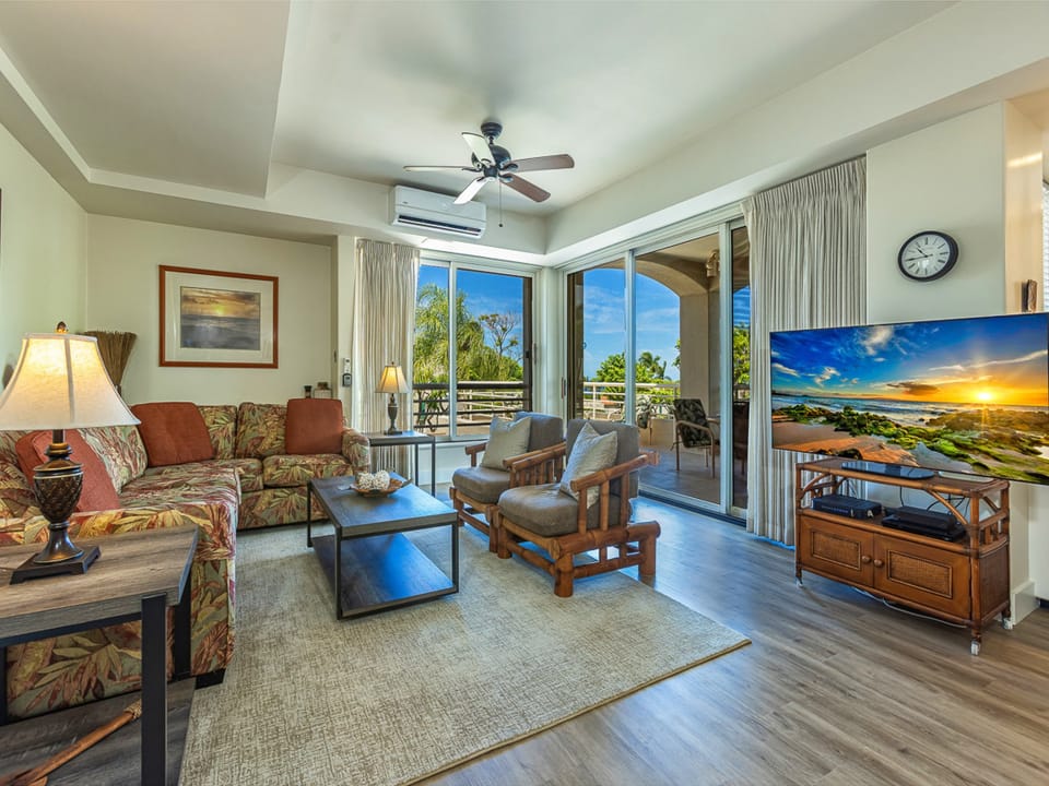 Unwind in your island-inspired living room, where tropical breezes flow through open balcony doors and every sunset paints the sky from your screen. Your perfect retreat awaits.