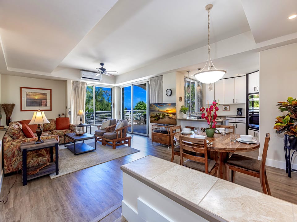 Step into this sun-filled open space where coastal elegance meets island comfort, blending a cozy living room, dining area, and modern kitchen into one inviting retreat for your perfect island getaway.