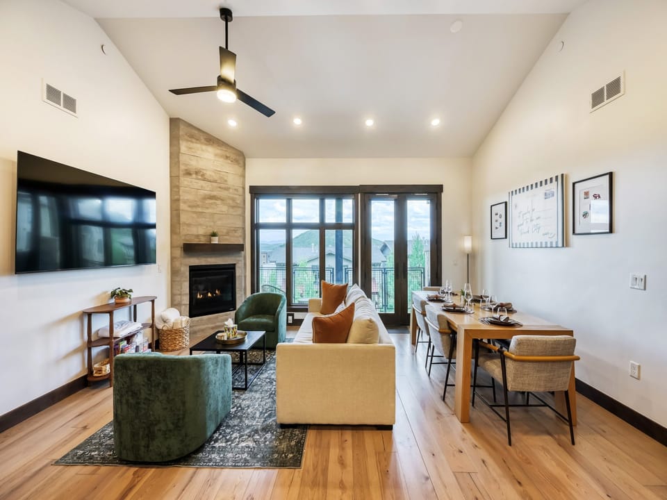 Relax in your open-concept living and dining space with vaulted ceilings, a cozy fireplace, and beautiful mountain views through your private balcony doors.