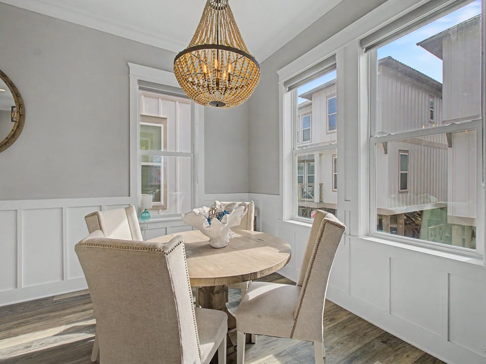 Sunlight floods the dining area as you gather around the table with soft, cushioned chairs