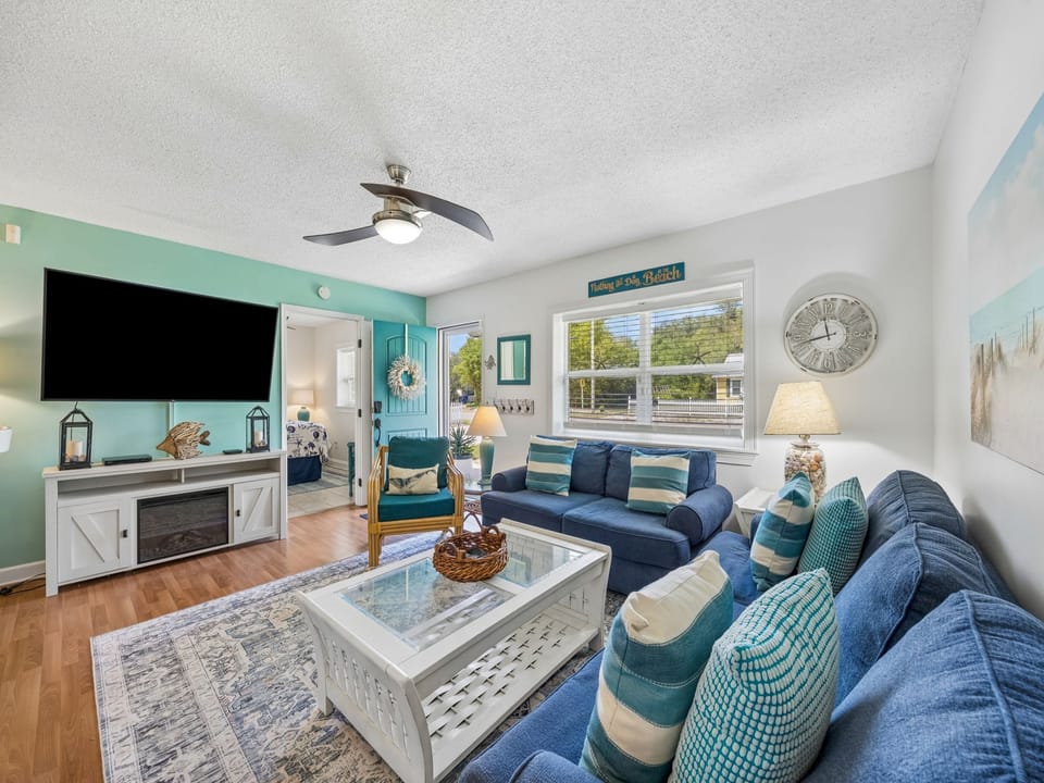 Sink into plush seating surrounded by calming coastal blues and whites—your perfect retreat for movie nights, morning coffee, or simply unwinding after a beach day.