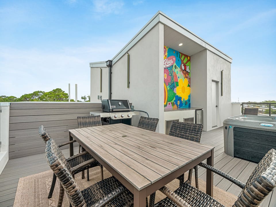 Your private rooftop retreat features a spacious dining table for alfresco meals, a grill for evening cookouts, and a hot tub where you can soak under the stars.