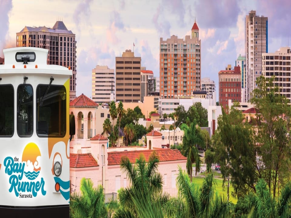 The Sarasota skyline and surrounding neighborhood provide a vibrant backdrop to your vacation getaway, with colorful architecture and lush greenery defining the area.
