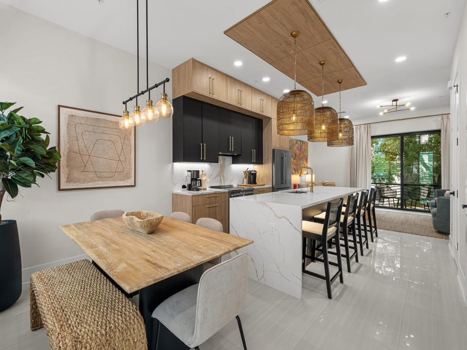 Your gourmet kitchen invites you to gather, cook, and connect. Sleek marble countertops, modern appliances, and an open design flow seamlessly into comfortable seating, perfect for shared meals and cherished moments.