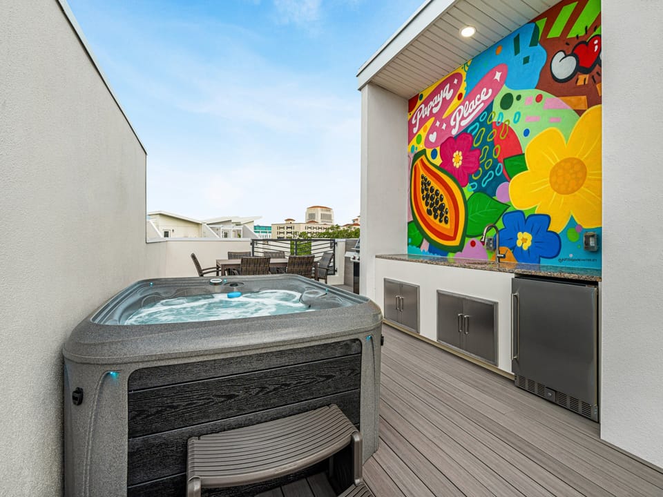 Soak away your worries in your private rooftop hot tub, with a vibrant mural and outdoor kitchen setting the scene for unforgettable evenings under the sky.