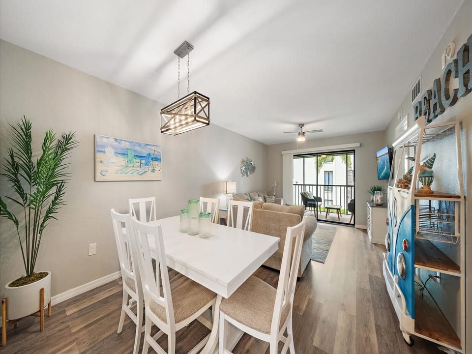 Step into your coastal retreat with an open dining and living area that flows effortlessly to your private balcony. Natural light fills the space, creating a bright, welcoming atmosphere perfect for relaxing after a day at the beach.