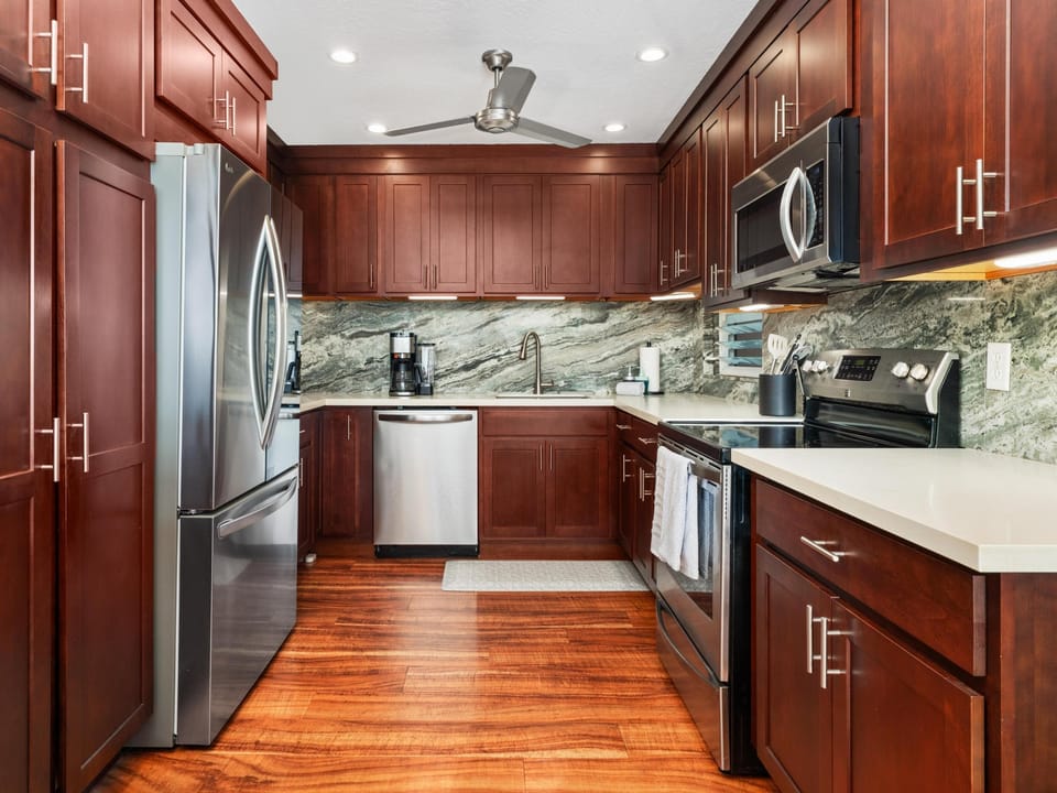 Cook your favorite meals in this fully-equipped kitchen with granite counters, stainless appliances, and rich cherry cabinetry.