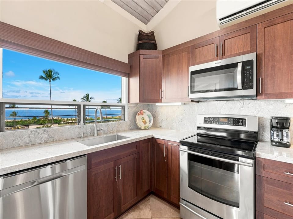 Your fully equipped kitchen awaits with modern appliances, gleaming countertops, and stunning ocean views that make every meal preparation a pleasure.