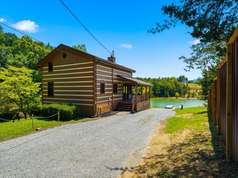 This charming log-style property sits on a private lakefront lot surrounded by lush woods and open skies, with easy driveway access and scenic water views.
