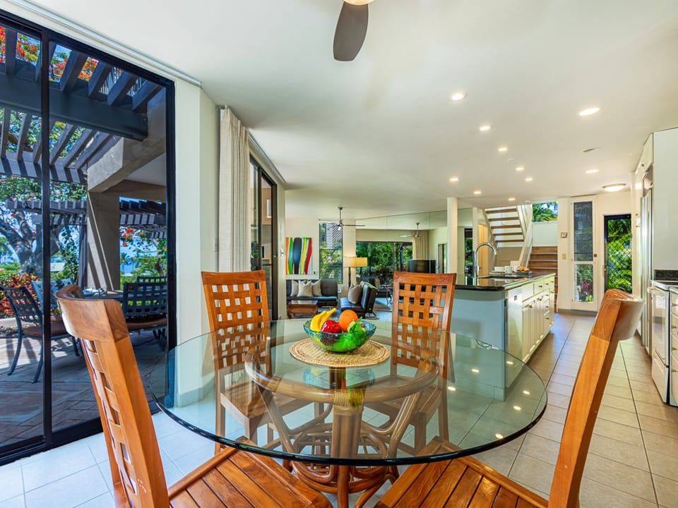 Gather around this inviting dining space with glass doors opening to your private patio. The open layout connects you to the kitchen and living areas, perfect for shared meals and conversation.