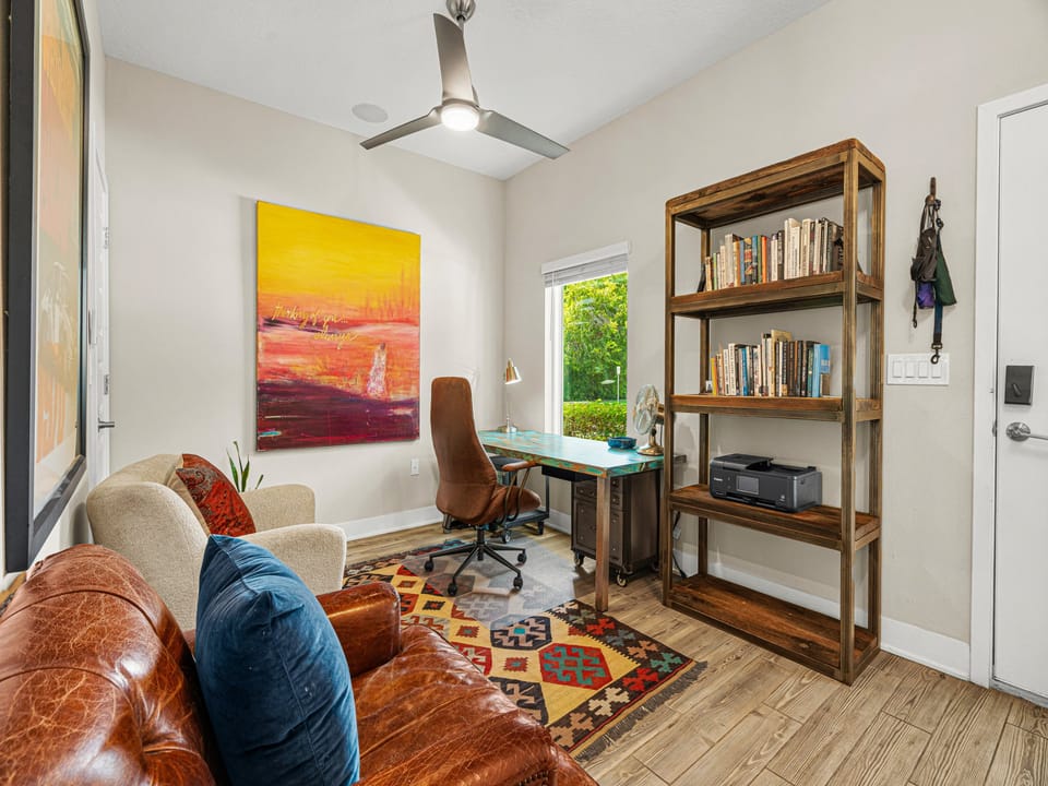 Work comfortably from your dedicated desk space, where natural light and breezy comfort from the ceiling fan create your perfect productivity spot.