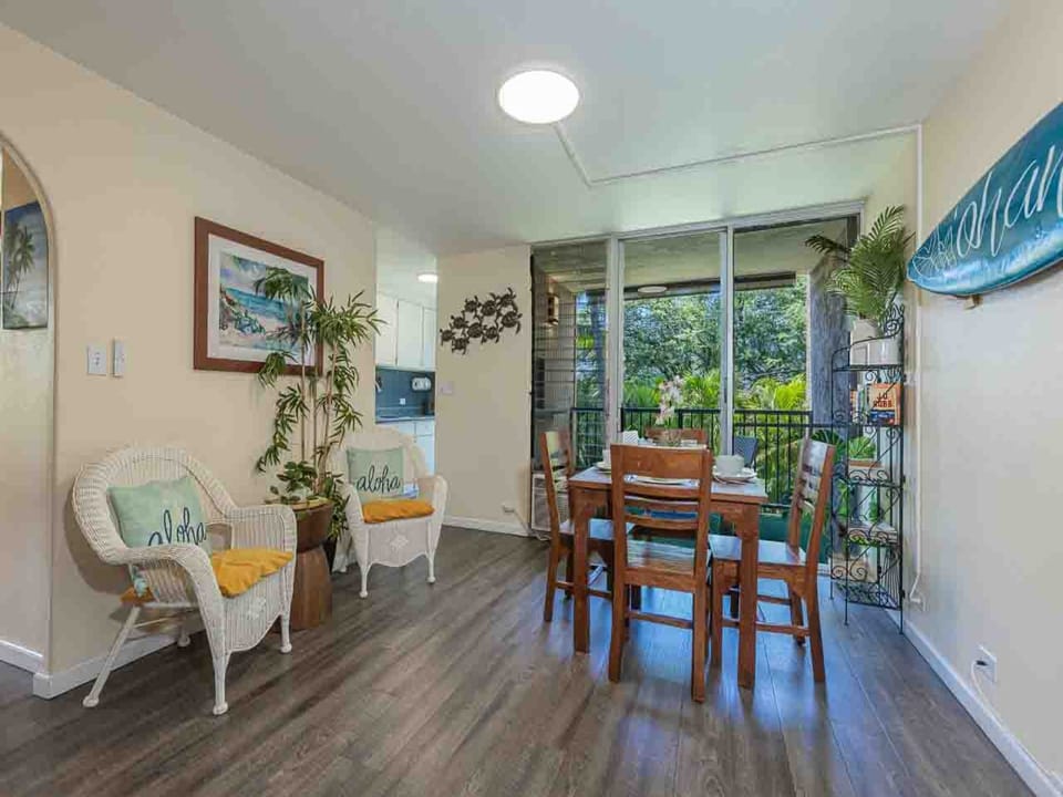 Large windows fill the space with natural light while offering views of lush greenery from your private lanai.